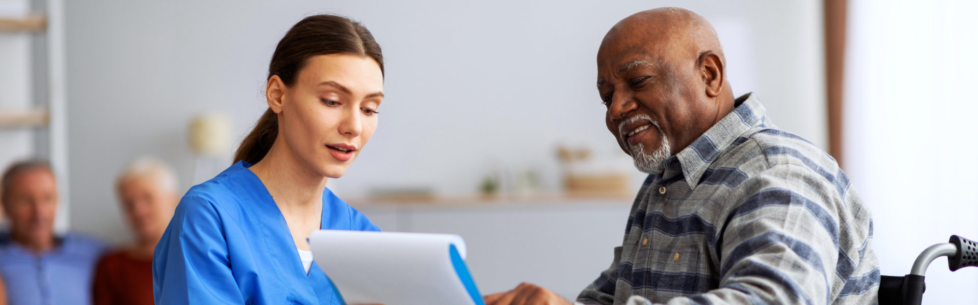 male aide smiling at the elderly woman