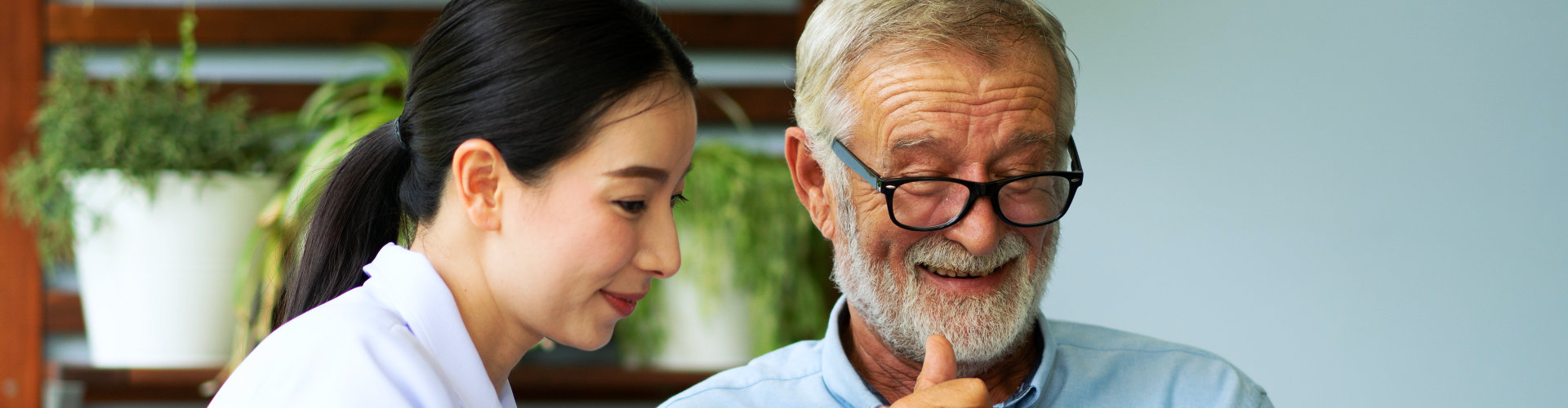 elderly man and aide talking