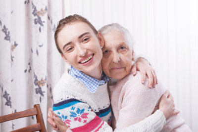 aide hugging elderly patient