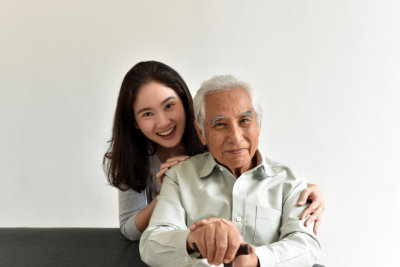 aide and elderly man smiling