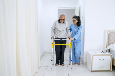 aide assisting an elderly man