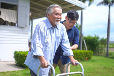 elderly man being assisted by his aide