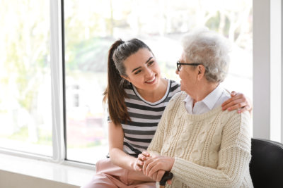 young woman talking to an elderly woman