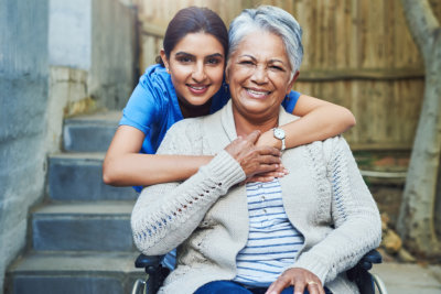 aide and elderly woman smiling