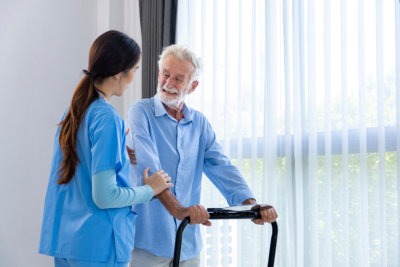 aide and elderly man smiling