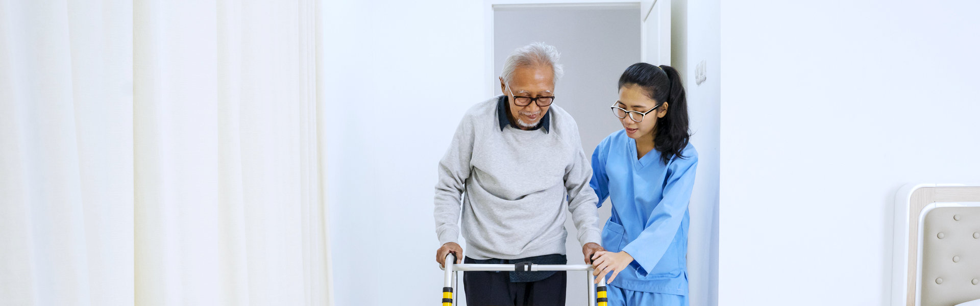 aide assisting an elderly man