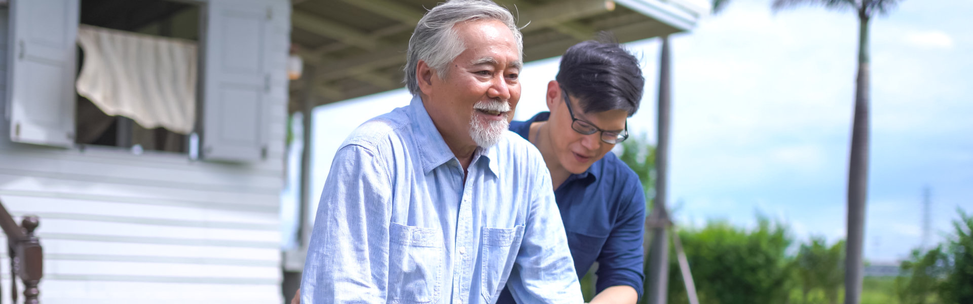 elderly man being assisted by his aide