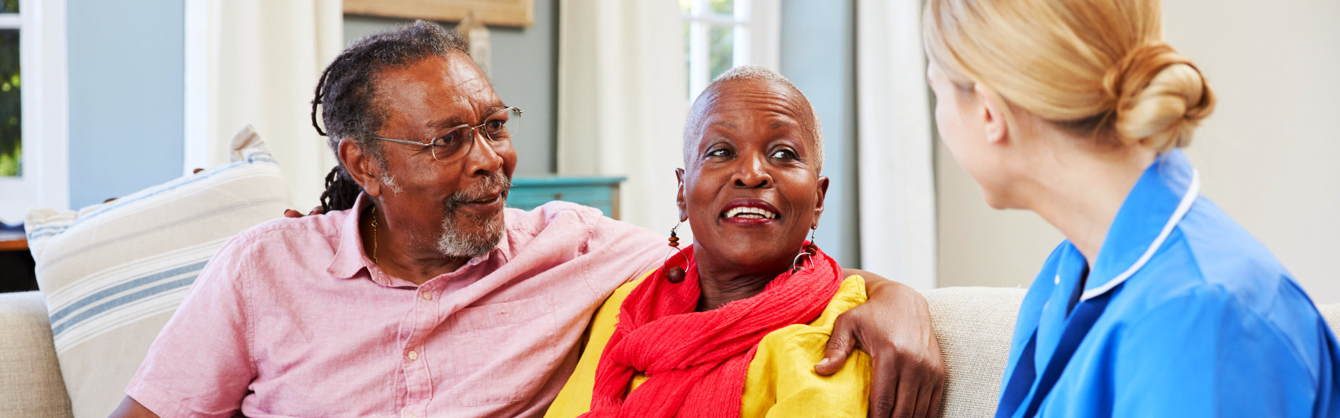 elderly couple talking to an aide