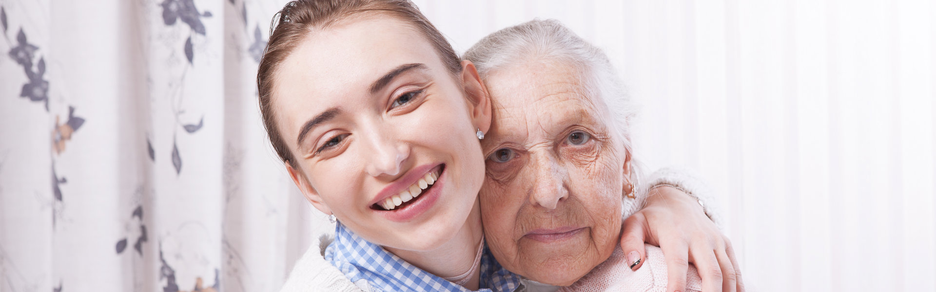 aide hugging elderly patient