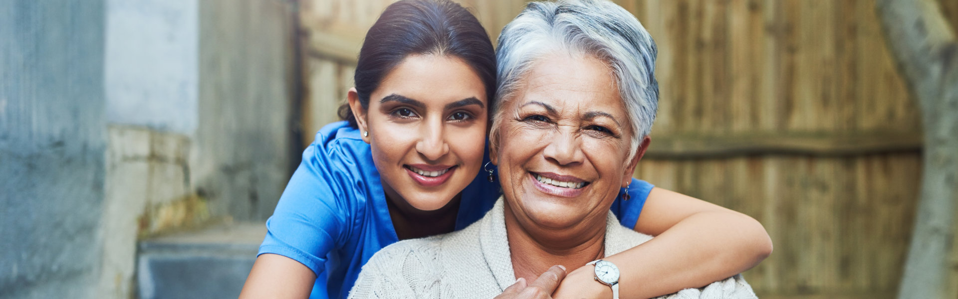 aide and elderly woman smiling