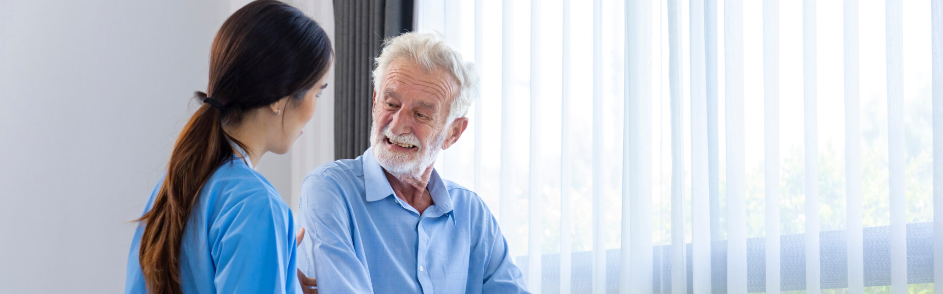 aide and elderly man talking